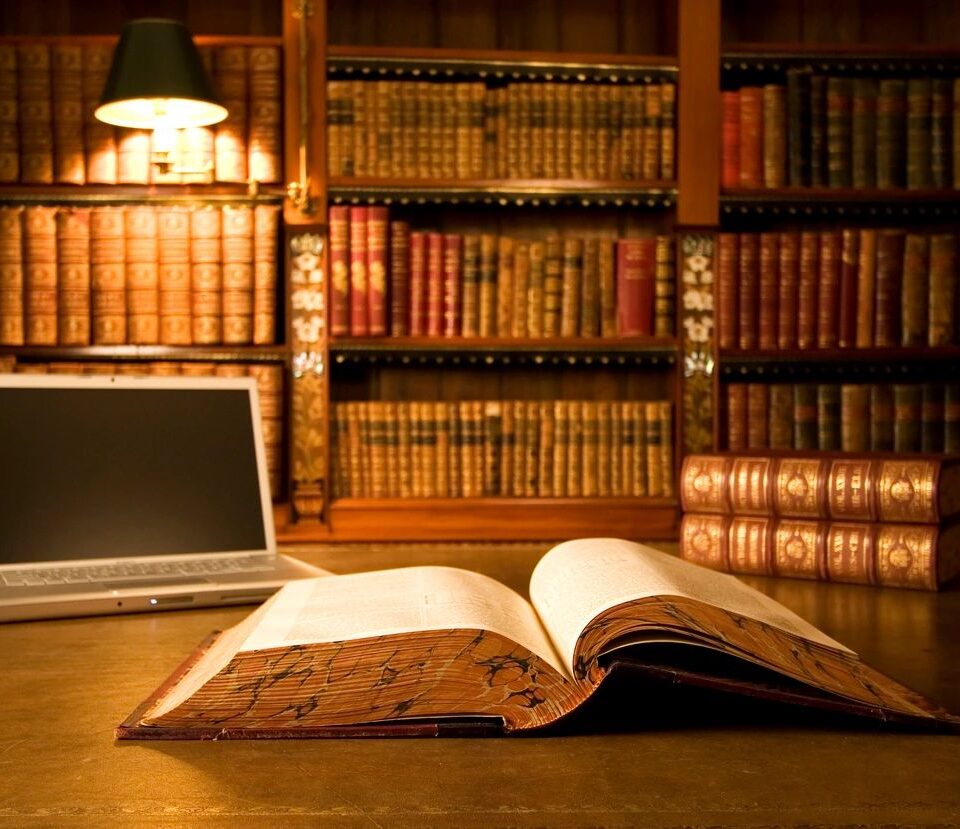 Open book in a library representing book-length works.